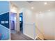 Bright hallway featuring a staircase and doorways leading to bedrooms, creating a welcoming and accessible space at 104 Pollentia Ave, North Las Vegas, NV 89084