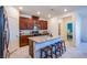Modern kitchen featuring a large island with barstool seating, granite countertops, and stainless steel appliances at 104 Pollentia Ave, North Las Vegas, NV 89084