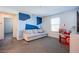 Inviting living room features a comfortable sofa, stylish geometric accent wall and a window with natural light at 104 Pollentia Ave, North Las Vegas, NV 89084
