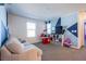 Comfortable living room with a stylish accent wall, cozy seating, and a functional layout for relaxation and entertainment at 104 Pollentia Ave, North Las Vegas, NV 89084