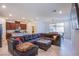 An open concept living room and kitchen area with a large sectional sofa at 104 Pollentia Ave, North Las Vegas, NV 89084