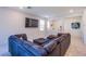 The comfortable living room has a spacious sectional and a TV mounted on the wall at 104 Pollentia Ave, North Las Vegas, NV 89084