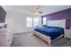 Spacious main bedroom with plenty of natural light, complemented by neutral tones and a ceiling fan at 104 Pollentia Ave, North Las Vegas, NV 89084
