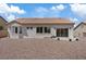 Rear exterior of house with minimal desert landscaping, mature shrubs and views of neighboring properties at 10809 Clarion Ln, Las Vegas, NV 89134