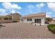 Spacious backyard featuring low-maintenance desert landscaping and a covered patio, perfect for outdoor living at 10809 Clarion Ln, Las Vegas, NV 89134