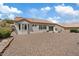Expansive low maintenance backyard is finished with neutral desert landscaping and mature trees at 10809 Clarion Ln, Las Vegas, NV 89134