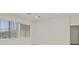 Spacious bedroom featuring two windows and a ceiling fan at 10809 Clarion Ln, Las Vegas, NV 89134