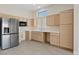 Bright kitchen features wood cabinets, stainless steel appliances, and laminate floors at 10809 Clarion Ln, Las Vegas, NV 89134