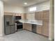 Bright kitchen features stainless steel appliances and neutral cabinetry at 10809 Clarion Ln, Las Vegas, NV 89134