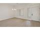 Open-concept living room with chandelier lighting and lots of natural light at 10809 Clarion Ln, Las Vegas, NV 89134