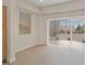 Bright living room features a sliding glass door with backyard views and a light-colored flooring at 10809 Clarion Ln, Las Vegas, NV 89134