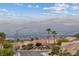 Picturesque street view of a community with palm trees, well-maintained homes, and mountain views in the distance at 10809 Clarion Ln, Las Vegas, NV 89134