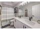 Well-lit bathroom featuring double sinks and a shower with a stylish shower curtain for added privacy at 11143 Castellane Dr, Las Vegas, NV 89141