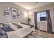 Cozy bedroom with neutral decor, a large window, and modern furnishings for a relaxing space at 11143 Castellane Dr, Las Vegas, NV 89141