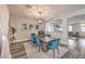 Bright dining room featuring a rustic wooden table, upholstered chairs, and modern lighting fixtures at 11143 Castellane Dr, Las Vegas, NV 89141