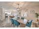Inviting dining room adjacent to a modern kitchen, featuring a large wooden table with stylish blue chairs at 11143 Castellane Dr, Las Vegas, NV 89141