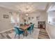 This spacious dining room features an elegant chandelier and modern decor and plenty of natural light at 11143 Castellane Dr, Las Vegas, NV 89141