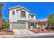 Charming two-story home featuring a well-manicured front yard and attached two-car garage, offering curb appeal at 11143 Castellane Dr, Las Vegas, NV 89141