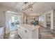 Bright kitchen with center island, stainless appliances, and sliding glass doors leading to the outdoor patio at 11143 Castellane Dr, Las Vegas, NV 89141