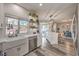 Spacious kitchen with a farmhouse sink, stainless steel dishwasher, and open layout to dining area at 11143 Castellane Dr, Las Vegas, NV 89141
