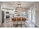 Modern kitchen with stainless steel appliances, center island with seating, and sliding glass doors to the patio at 11143 Castellane Dr, Las Vegas, NV 89141