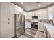 Well-lit kitchen featuring white cabinets, stainless steel appliances, and stylish countertops at 11143 Castellane Dr, Las Vegas, NV 89141