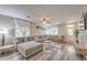 Spacious living room with wood floors, plenty of natural light and a comfortable sectional at 11143 Castellane Dr, Las Vegas, NV 89141