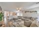 Spacious living room featuring an open floor plan, wood floors, and comfortable sectional at 11143 Castellane Dr, Las Vegas, NV 89141