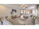 Comfortable living room with a large sectional sofa, modern decor, and an open view to the dining area at 11143 Castellane Dr, Las Vegas, NV 89141