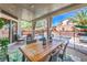 Outdoor patio with a dining table, chairs, a leaf patterned rug, and a view of the pool area at 11143 Castellane Dr, Las Vegas, NV 89141