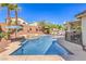 Beautiful backyard with a sparkling pool, relaxing lounge chairs, and lush landscaping under clear skies at 11143 Castellane Dr, Las Vegas, NV 89141