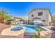 Relaxing backyard oasis boasts a sparkling pool with a jacuzzi, palm trees, and lounge area at 11143 Castellane Dr, Las Vegas, NV 89141