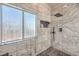 Elegant marble shower featuring a rain shower head, niche, and decorative window for natural light at 11143 Castellane Dr, Las Vegas, NV 89141