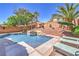 Beautiful backyard swimming pool with a spa, surrounded by lush greenery and lounge chairs, perfect for relaxation and enjoyment at 11143 Castellane Dr, Las Vegas, NV 89141
