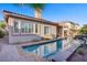 Stunning backyard showcasing a pool, spa, and covered patio for ultimate relaxation and enjoyment at 11369 Rancho Villa Verde Pl, Las Vegas, NV 89138
