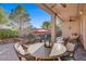 Inviting backyard with a stone-lined pool, spa, and covered patio perfect for entertaining at 11369 Rancho Villa Verde Pl, Las Vegas, NV 89138