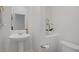 Elegant powder room features a pedestal sink, white walls, and decorative accents, providing a clean and stylish space at 11369 Rancho Villa Verde Pl, Las Vegas, NV 89138