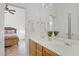 Bright bathroom with double sinks and a view into the main bedroom at 11369 Rancho Villa Verde Pl, Las Vegas, NV 89138