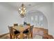 Elegant dining area featuring a modern chandelier and a wooden table with chairs at 11369 Rancho Villa Verde Pl, Las Vegas, NV 89138