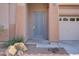 Charming front door with a modern design, enhancing curb appeal and security of this inviting home at 11369 Rancho Villa Verde Pl, Las Vegas, NV 89138