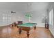 Game room featuring a pool table, comfortable leather seating, and bright natural light at 11369 Rancho Villa Verde Pl, Las Vegas, NV 89138