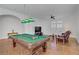 Game room featuring a pool table with bright overhead lighting and comfortable seating in the background at 11369 Rancho Villa Verde Pl, Las Vegas, NV 89138