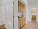 Hallway with built-in cabinets for storage and a laundry room at 11369 Rancho Villa Verde Pl, Las Vegas, NV 89138