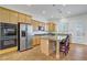 Bright kitchen with an island, stainless steel appliances, and granite countertops at 11369 Rancho Villa Verde Pl, Las Vegas, NV 89138