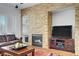 Inviting living room features a stone fireplace, recessed lighting, and comfortable seating, creating a cozy atmosphere at 11369 Rancho Villa Verde Pl, Las Vegas, NV 89138