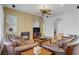 Cozy living room showcasing a stone fireplace and neutral decor, perfect for relaxing and entertaining at 11369 Rancho Villa Verde Pl, Las Vegas, NV 89138