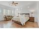 Spacious main bedroom with a cozy seating area, decorative lamps, and shuttered windows, providing ample light and comfort at 11369 Rancho Villa Verde Pl, Las Vegas, NV 89138