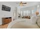Inviting main bedroom with a cozy fireplace, comfortable seating, and large windows, creating a relaxing retreat at 11369 Rancho Villa Verde Pl, Las Vegas, NV 89138