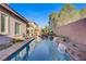 A pristine pool features a relaxing waterfall and a neatly kept patio, making it an ideal outdoor escape at 11369 Rancho Villa Verde Pl, Las Vegas, NV 89138