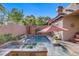 Beautiful backyard pool and spa with a soothing waterfall feature, surrounded by lush landscaping at 11369 Rancho Villa Verde Pl, Las Vegas, NV 89138
